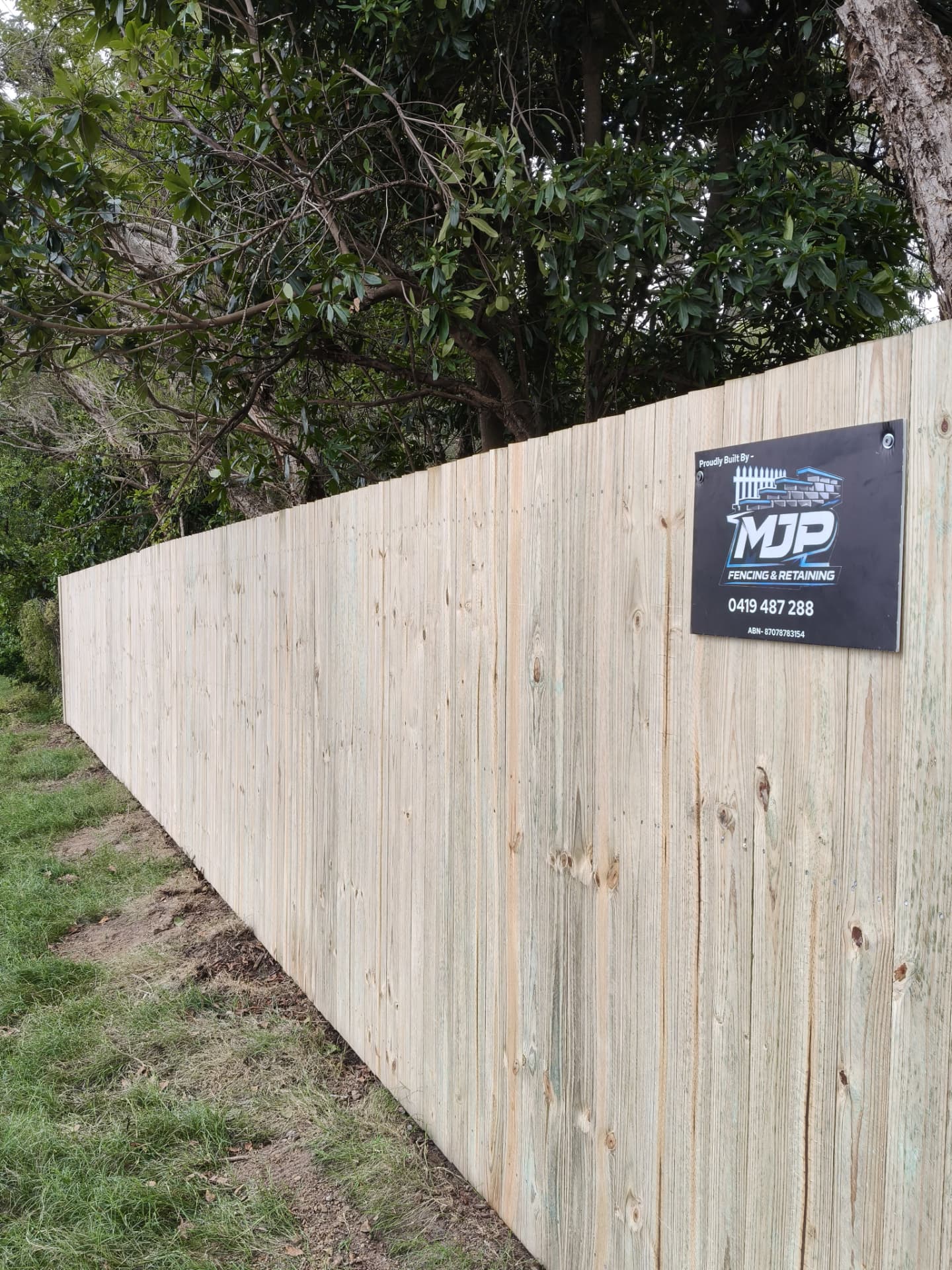 Hardwood paling fence with MJP Fencing & Retaining sign