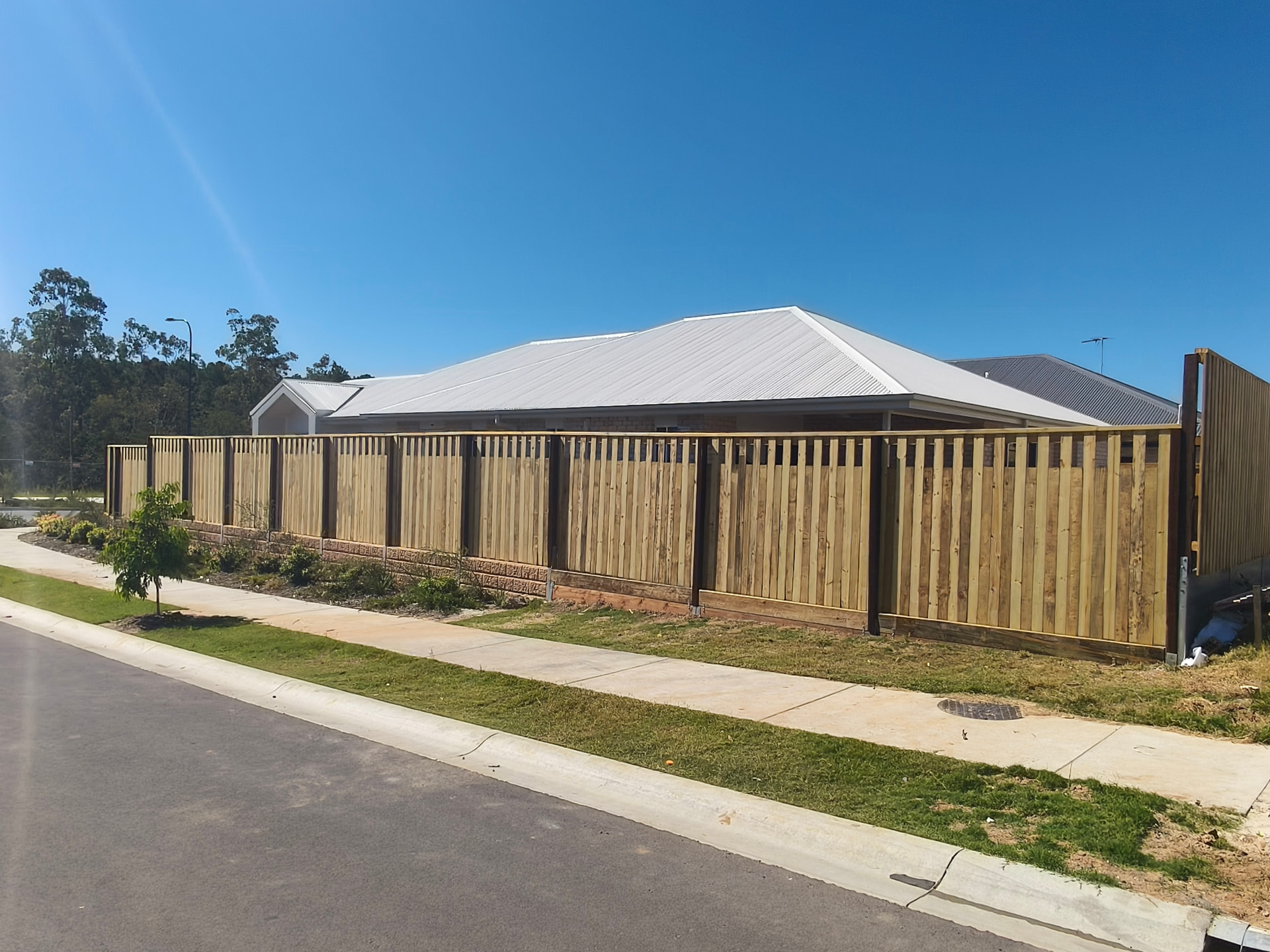 Timber boundary fence along a new Brisbane home